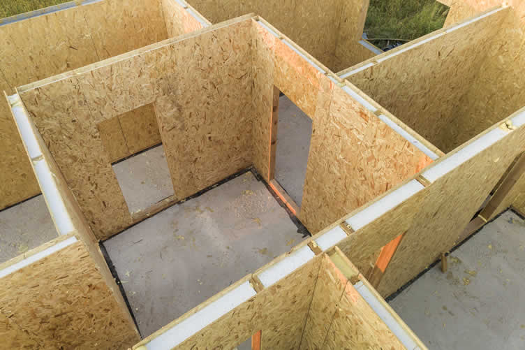 SIP panels being craned into place - structural construction and insulation