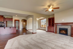 Unfurnished Living Room with Part Carpet and Wood Flooring