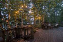 Wooden Deck Near Lake with Lighted Features