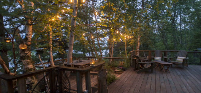Wooden Deck Near Lake with Lighted Features